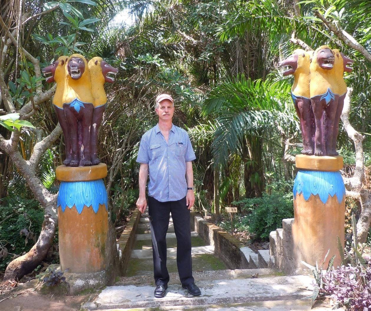 Robert beside two decorative figures