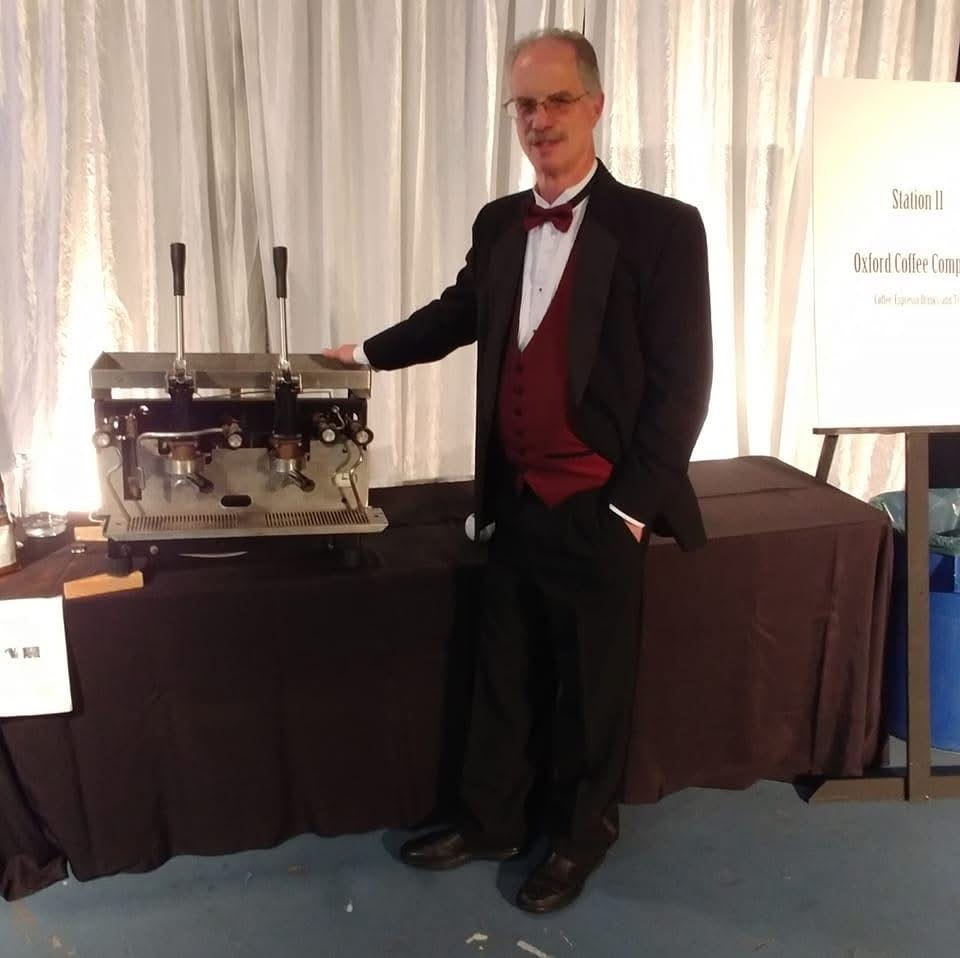 Robert W. Thurston beside an espresso machine